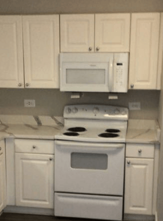 Kitchen with white cabinets and white appliances